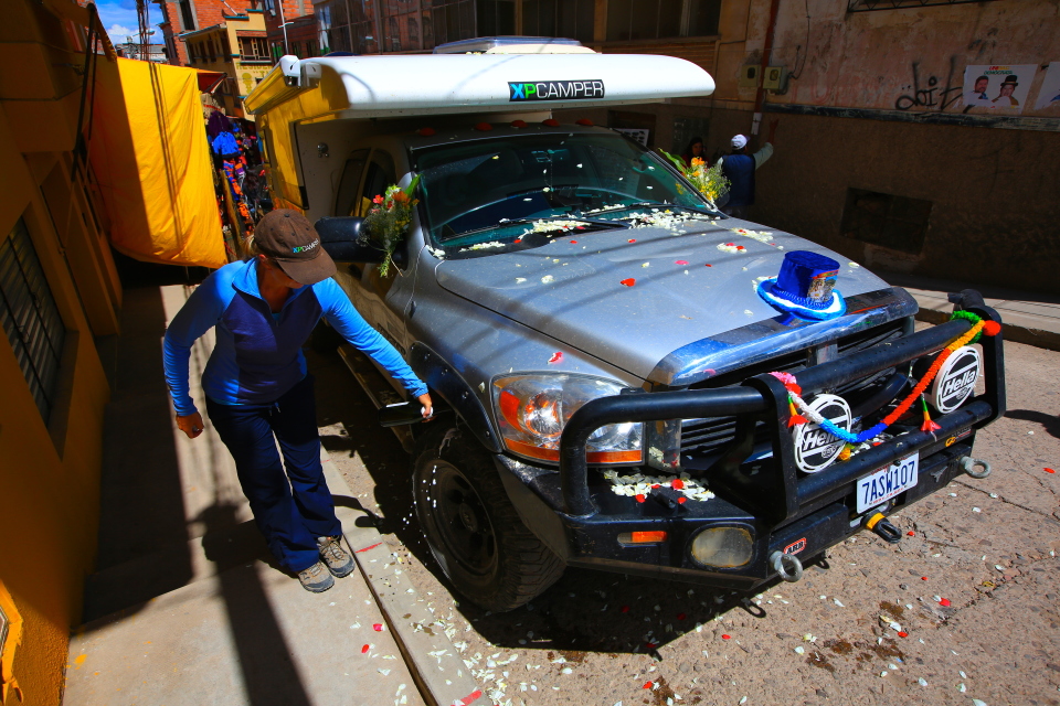 After the blessing, you're supposed to open a bottle of champagne and pour it on the parts of the car.  We focused on the tires!