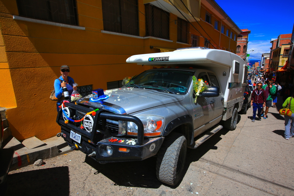 Erica preps the XPCamper for it's blessing.  We had flowers, champagne, and..  what's that on the hood of the truck?  Yes, my friend, it is a top hat.  I'm not sure why, but as soon as we saw it we knew we needed to buy it.