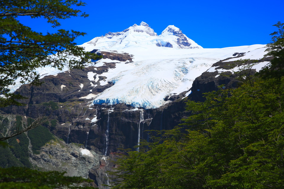 As you get higher up the tree line you see that the glacier has a waterfall plunging out of it!